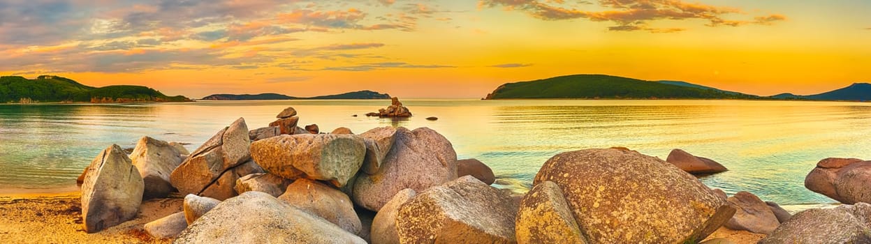 Amazing landscape at sunset. Stones on the foreground. Panorama