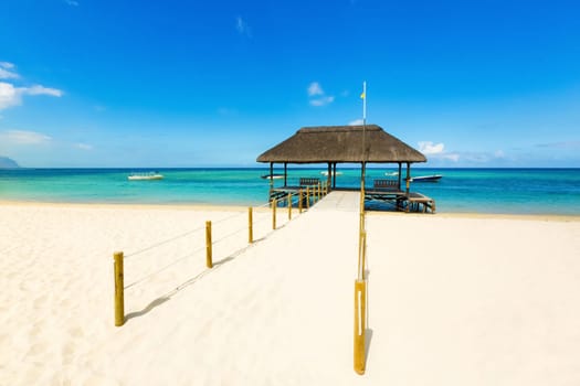 Sandy tropical Wolmar beach at sunny day. Jetty on the foreground.  Mauritius