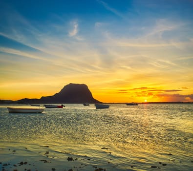 Fishing boat at sunset time. Le Morn Brabant on background. Mauritius.