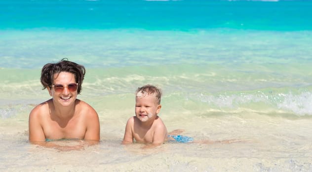 Mother and son relaxing in the sea. Mauritius. Panorama