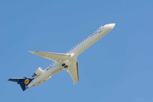 Munich, Germany - May 6, 2016: Aircraft Bombardier Canadair Regional Jet 900 CRJ-900 of Lufthansa Regional CityLine airlines taking off from Munich international airport and gains altitude