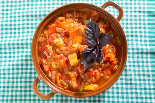 Closeup of delicious stew with mixed vegetables, arranged with green and purple leaves