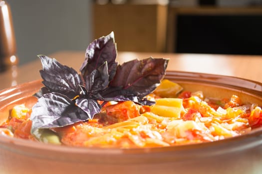 Closeup of delicious stew with mixed vegetables, arranged with purple leaves