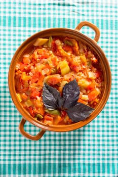 Closeup of delicious stew with mixed vegetables, arranged with green and purple leaves