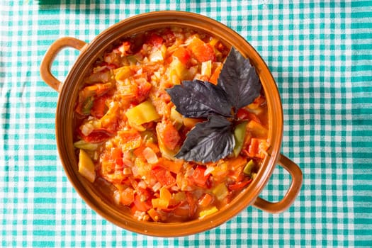 Closeup of delicious stew with mixed vegetables, arranged with green and purple leaves