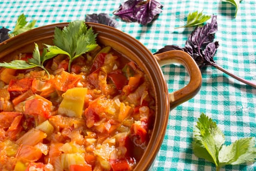 Closeup of delicious stew with mixed vegetables, arranged with green and purple leaves