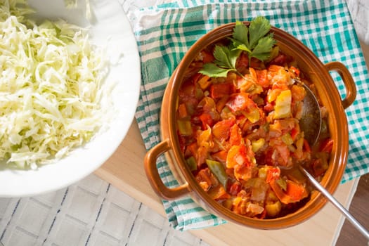 Stewed vegetables on a table with salad