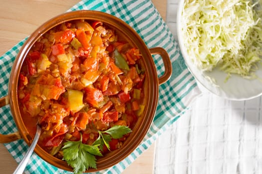 Closeup of delicious stew with mixed vegetables, arranged with green and purple leaves