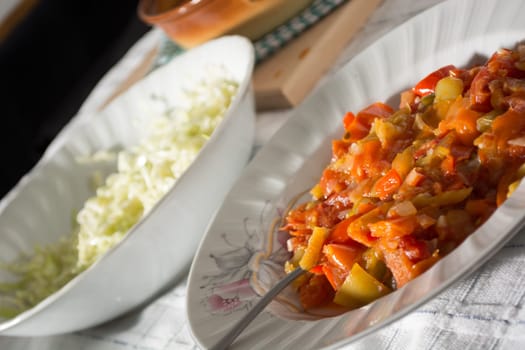 Stewed vegetables on a table with salad