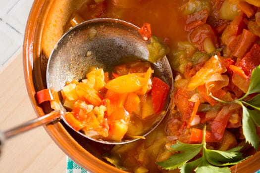 Closeup of vegan stew, half eaten with ladle