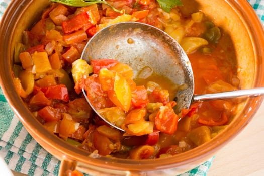 Closeup of vegan stew, half eaten with ladle