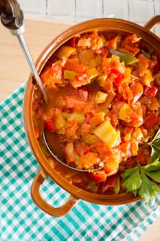Closeup of vegan stew, half eaten with ladle