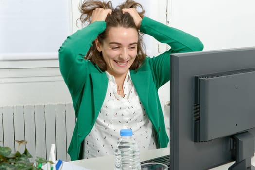 beautiful young business woman angry with her computer