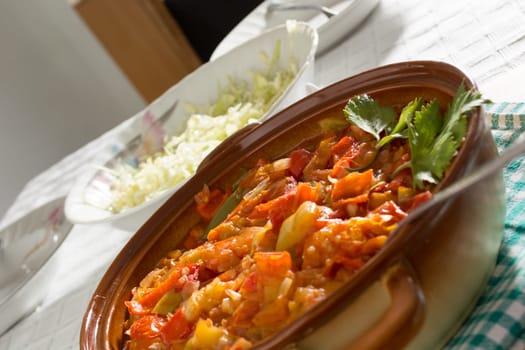 Closeup of delicious stew with mixed vegetables, arranged with green and purple leaves