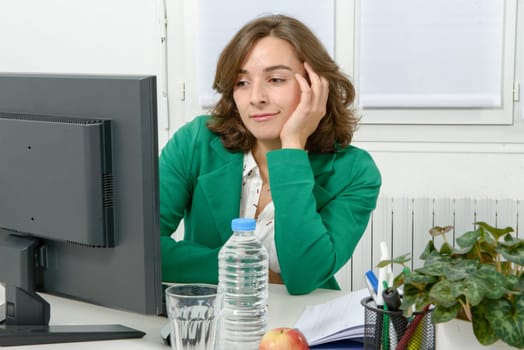Portrait of a young business woman with a green jacket