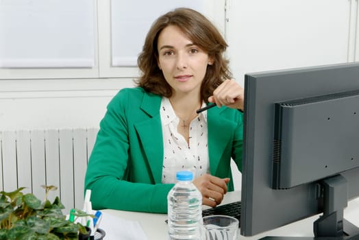 Portrait of a young business woman with a green jacket
