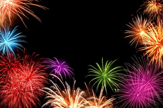 Gorgeous multi-colored fireworks as a border on black background,ideal for New Year or other celebration events