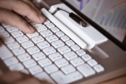Businessman hands busy using laptop at office desk