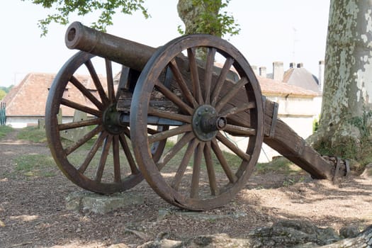 antique cannon with wooden wheels, outdoors