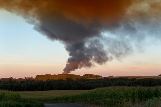 big smoke of a fire at sunset