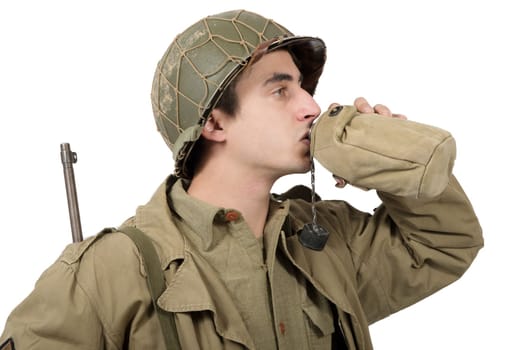 young American soldier drink water in his can, world war two