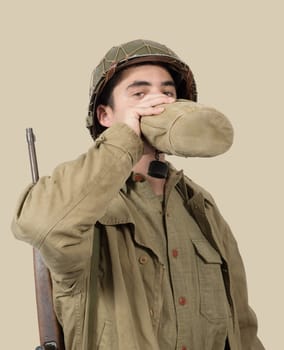 young American soldier drink water in his can, world war two