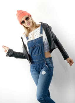 fashion young blonde woman with jeans overalls and black jacket