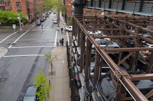 NEW YORK CITY - MAY 1, 2016: Due to lack of space cars are parked on elevated parking places in Chelsea, a neighbourhood in Manhattan