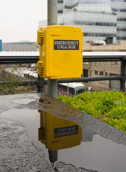 yellow emergency call box in New York for assistance in case of an emergency