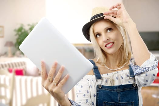 beautiful blond middle-aged woman with tablet computer