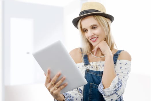 beautiful blond middle-aged woman with tablet computer