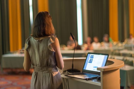 Female speaker at Business Conference and Presentation. Audience at the conference hall. Business and Entrepreneurship. Business woman. Horizontal composition.