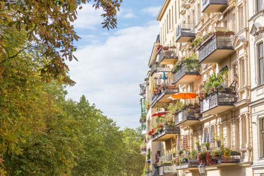 Traditional European residential house with balconys with colorful flowers and flowerpots. Kreuzberg neighborhood, Berlin, Germany