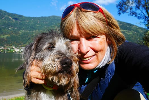 Woman takes selfie with dog on vacation