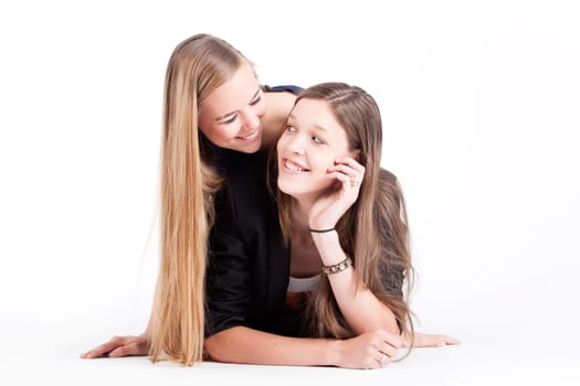 Two happy young girls on a white background in the studio