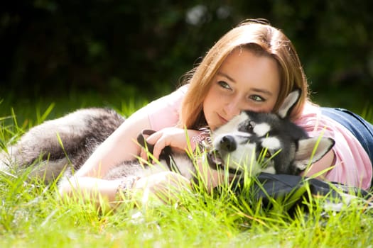 Young woman and her husky in the forest