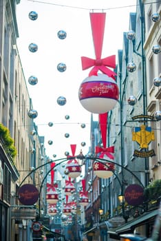 LONDON, UK - NOVEMBER 20: low angle shot of Christmas decoration in St. Christopher's Place. November 20, 2014 in London. The traditional pedestrianised street is home to high end retail units.