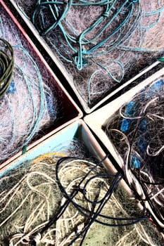 Old fishing nets in container on dock