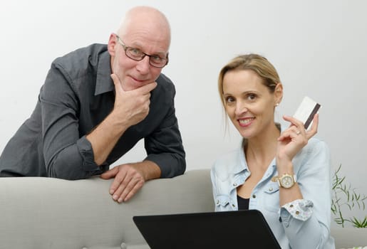 mature couple e-shopping on internet at home
