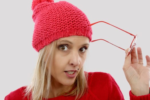 Beautiful young blonde woman with a red winter hat isolated on white background