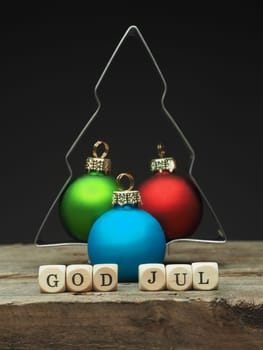 Baking tin tree shape with small wooden dices and the words God Jul, Scandinavian Merry Christmas