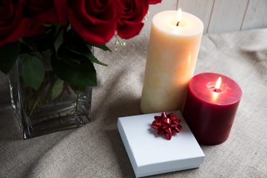 Gift box and two candles with roses