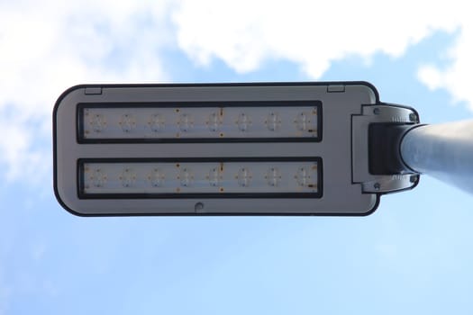 A street lamp with a blue sky in the background.