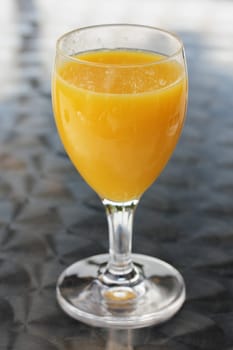 A glass filled with fruit juice.