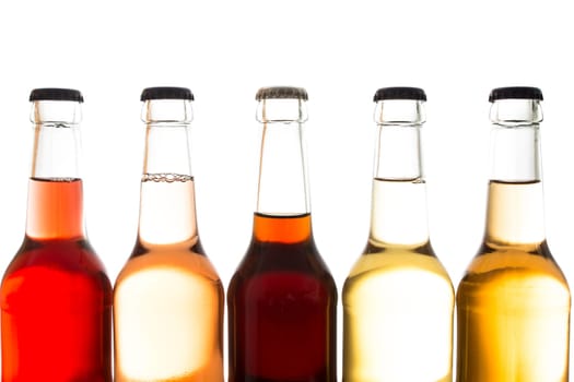 Sodas and cola in bottles of glass in backlight