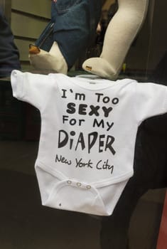 NEW YORK - MAY 2, 2016: Funny baby body suit with text in a souvenir shop in Manhattan