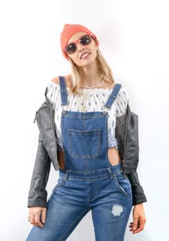 fashion young blonde woman with jeans overalls and black jacket