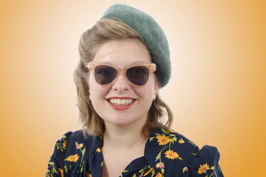 Portrait of a beautiful smiling woman with vintage clothes and sunglasses
