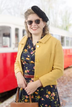 pretty young woman with clothes 1940, old train background