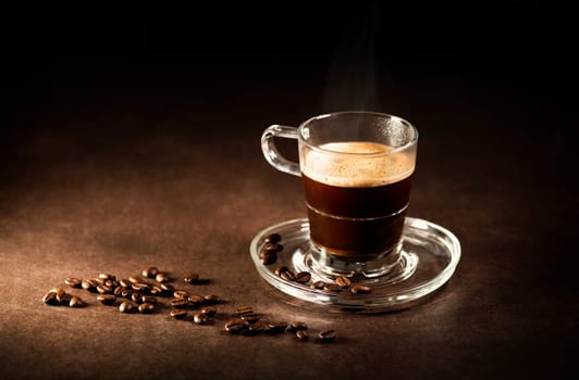 Cup of espresso coffee on dark background.